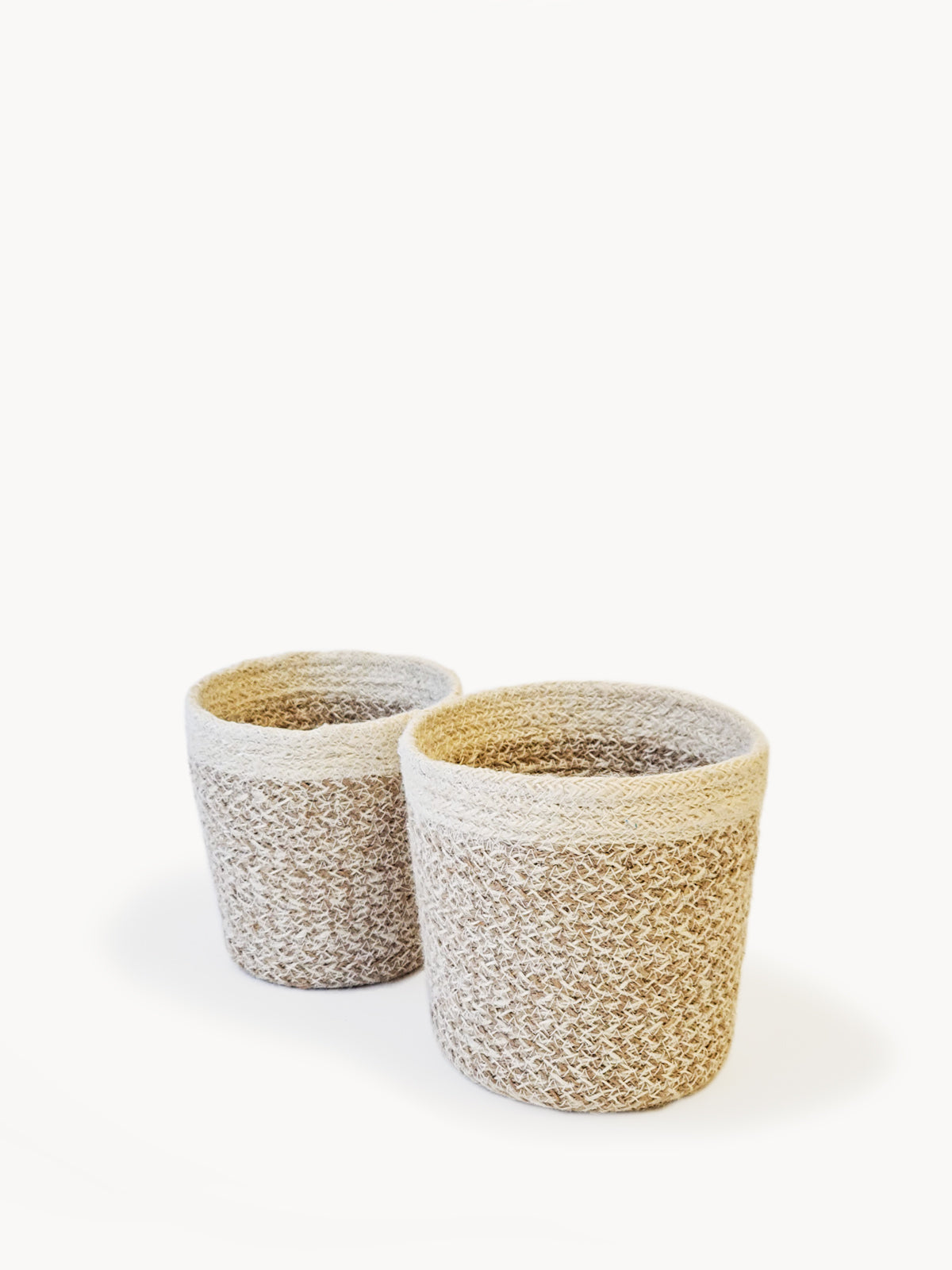 The Agora Plant Baskets in a light brown and cream pattern are showcased side by side on a plain white background, highlighting sustainable home decor crafted by Fair Trade artisans.