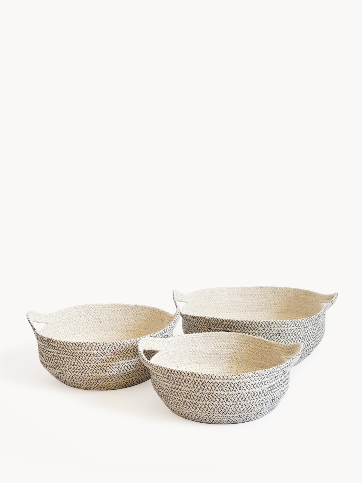 Three Amari Fruit Bowls in black are elegantly arranged on a white background. Handcrafted by Fair Trade artisans, these sustainably made pieces add an eco-friendly touch to any space.