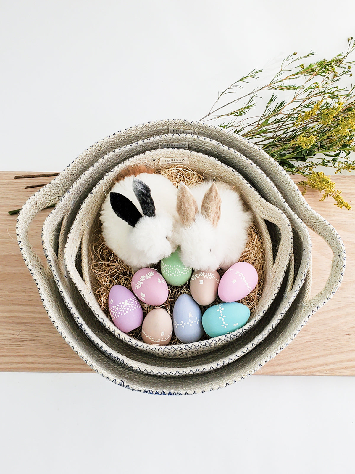 Three Amari Fruit Bowls in black are elegantly arranged on a white background. Handcrafted by Fair Trade artisans, these sustainably made pieces add an eco-friendly touch to any space.