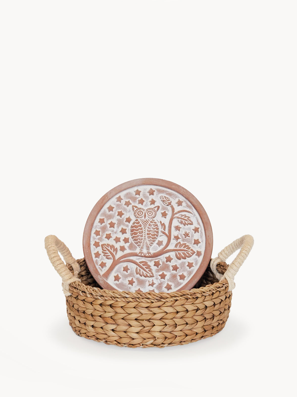 The Bread Warmer & Basket - Owl Round features a sustainably handmade woven basket paired with a round ceramic bread warmer, beautifully adorned with an enchanting owl design among twinkling stars and branches.