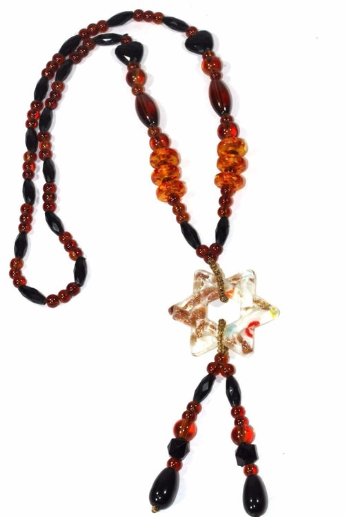 The Star Pendant Gypsy Style Shimmer Necklace features handmade jewelry with colored glass beads and a star-shaped pendant that displays a captivating blue and orange swirl pattern.