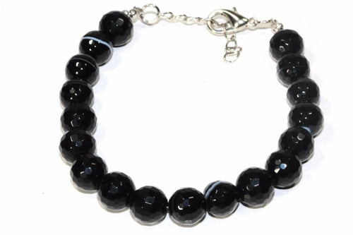 The Black Agate Yoga Bracelet showcases faceted beads and a silver clasp, designed to enhance inner strength and elegance.