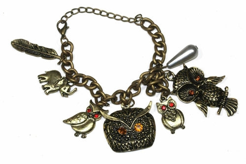 The Owl, Elephant & Feather Charm Bracelet combines an antique style in bronze tones with whimsical owl and elephant charms, accented by a delicate feather and wing.
