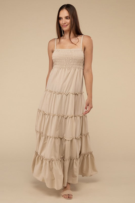A woman modeling a Woven Smocked Top Tiered Cami Maxi Dress against a neutral background.