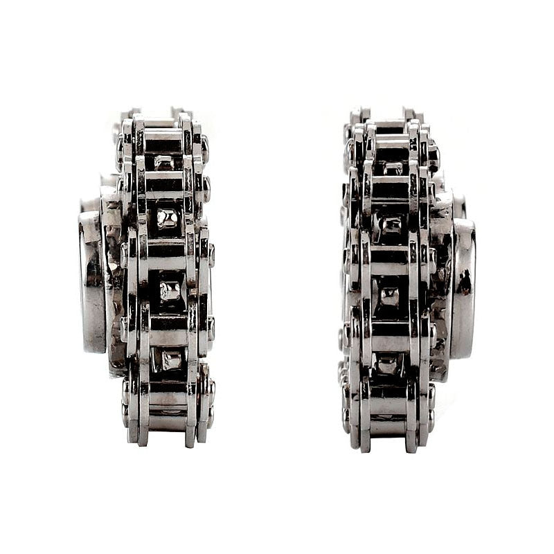 A Bike Chain Gear Spinner with two rivets lies on a glossy white surface, evoking the image of a sleek gear fidget spinner crafted for contemporary stress relief.
