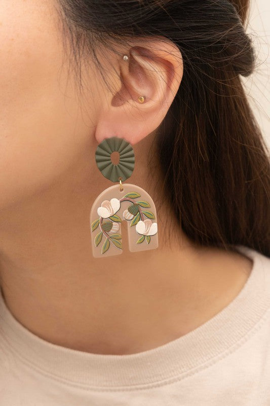 A pair of Terrace Drop Earrings with a floral vine image displayed against a light background.