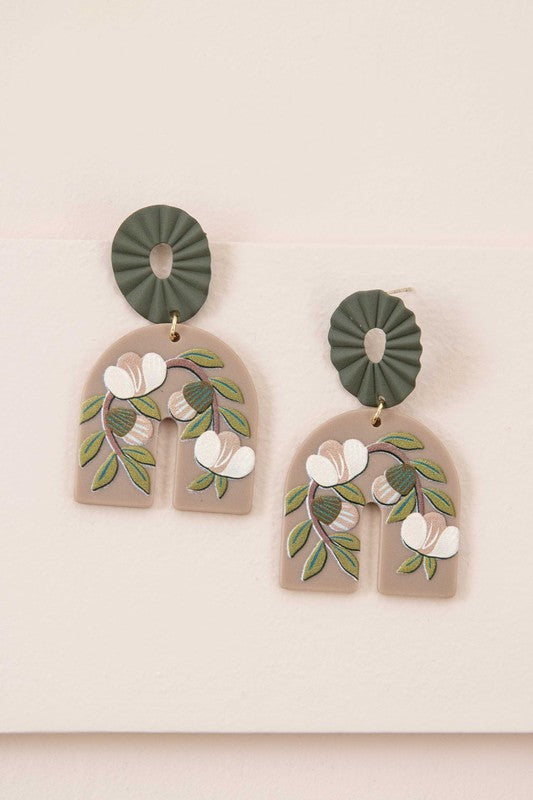 A pair of Terrace Drop Earrings with a floral vine image displayed against a light background.