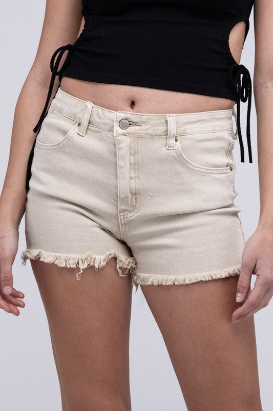Close-up of a person wearing Acid Washed Frayed Cutoff Hem Shorts and a black top with lace-up details on the side.