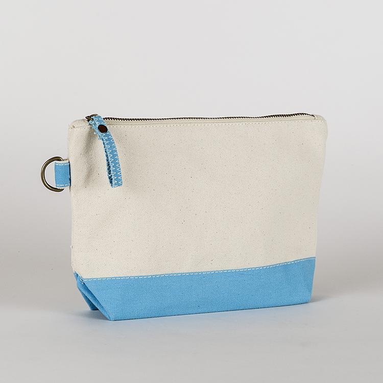 A small heavyweight canvas pouch with a black bottom, featuring a sturdy metal zipper and side loop detail, from the All In Zip Top Pouch collection.