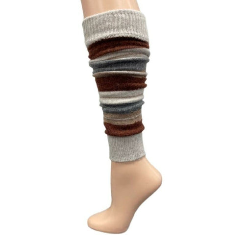 The Girl's Stripe Lambswool Knee Hi Leg Warmers, adorned with colorful stripes in blue, pink, purple, and white, are showcased on a mannequin leg as cozy essentials for the cold season.