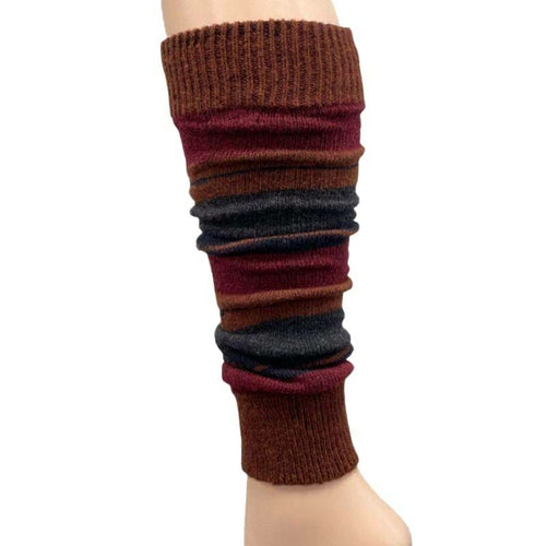 The Girl's Stripe Lambswool Knee Hi Leg Warmers, adorned with colorful stripes in blue, pink, purple, and white, are showcased on a mannequin leg as cozy essentials for the cold season.