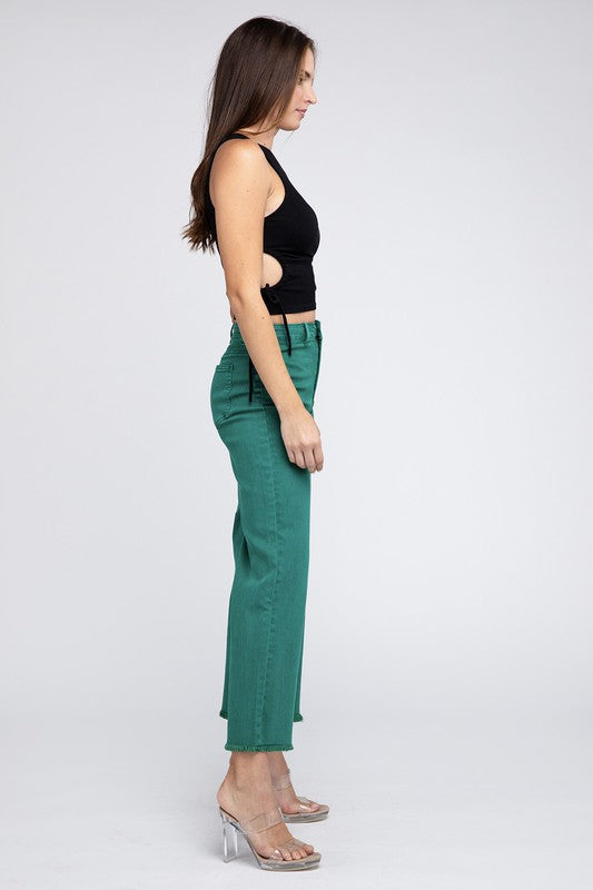 A person with long hair is wearing a sleeveless black top and gray Acid Wash Frayed Cutoff Hem Straight Wide Pants, posing against a plain, light-colored background. They are standing with hands on hips, smiling slightly.