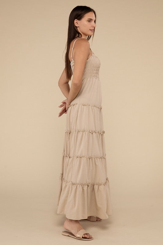 A woman modeling a Woven Smocked Top Tiered Cami Maxi Dress against a neutral background.