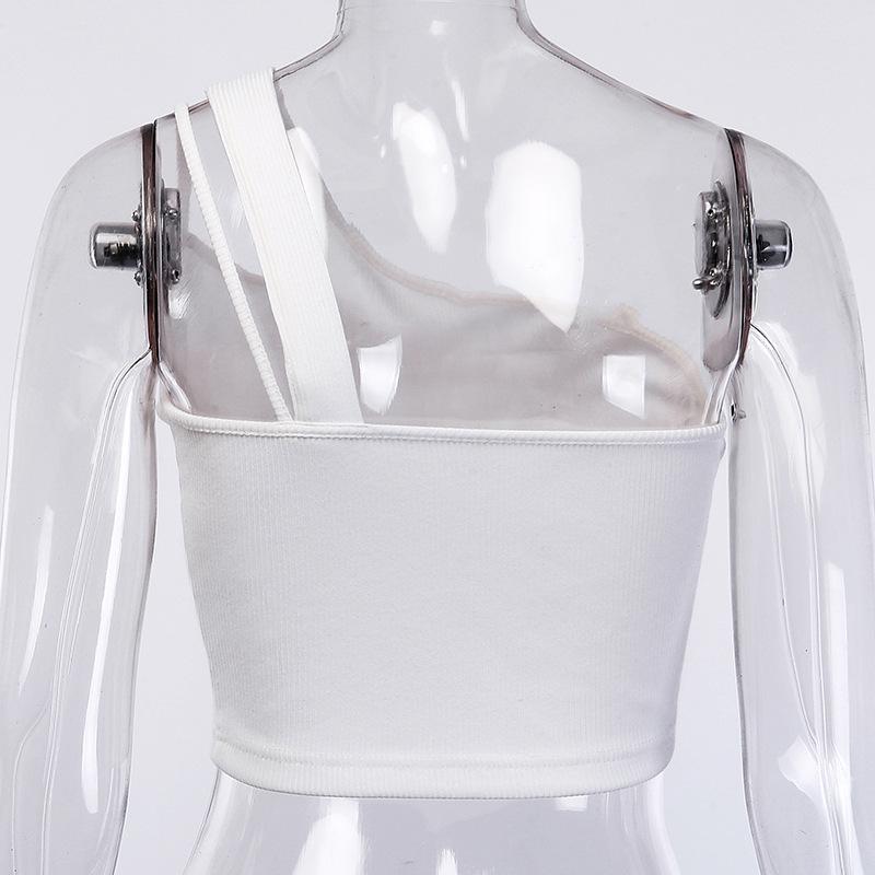 A woman wearing a One shoulder drawstring sexy crop top Elegant bodycon women and high-waisted white trousers in an indoor setting.