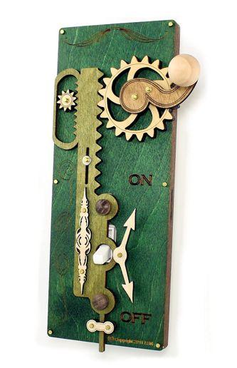 The Single Rack & Pinion Switch Plate Green 8000E showcases a wooden mechanical design with decorative gears and levers. With "ON" and "OFF" indicators, it’s mounted on a Kelly Green board, adding an artful touch to any decor.