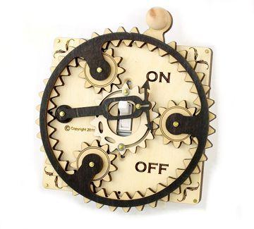 The Single Planetary Switch Plate 8002F Natural Wood features a wooden gear mechanism with a central switch labeled "ON" and "OFF," combining natural wood and black satin accents for an elegant touch.