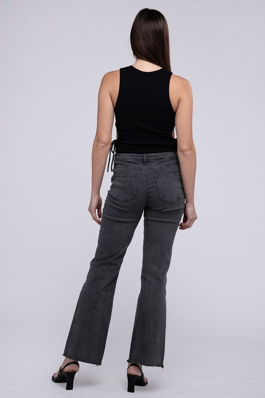 A person standing in Acid Washed Frayed Cutoff Hem Straight Wide Pants with black heeled sandals against a plain background.