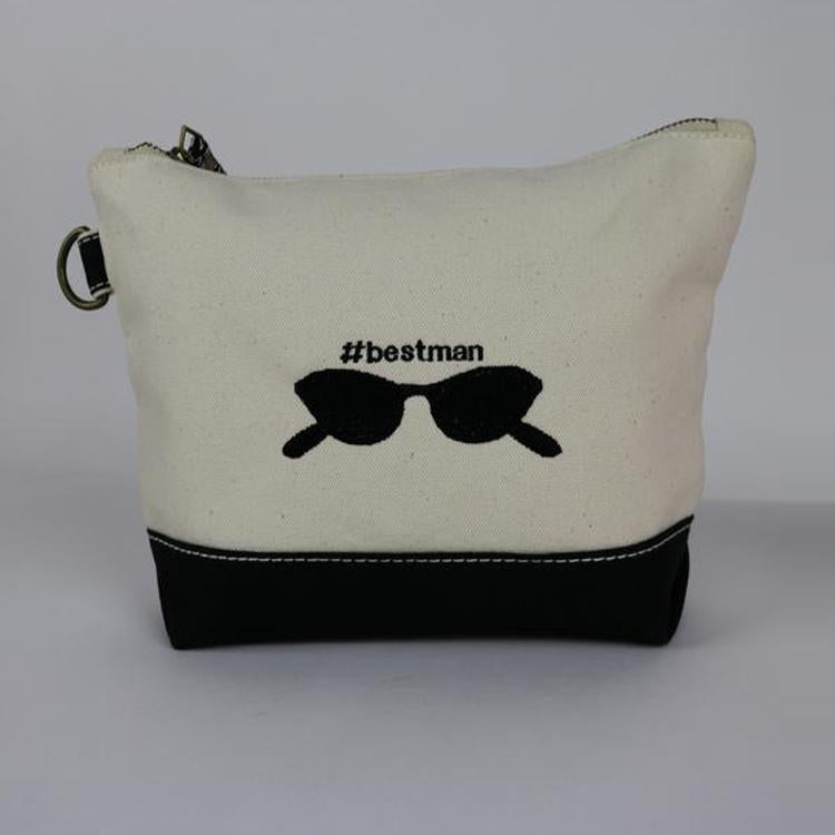 A small heavyweight canvas pouch with a black bottom, featuring a sturdy metal zipper and side loop detail, from the All In Zip Top Pouch collection.