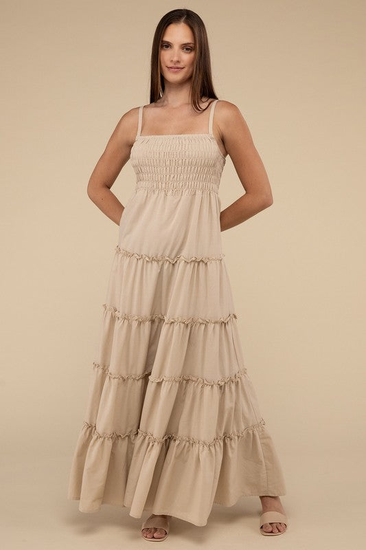 A woman modeling a Woven Smocked Top Tiered Cami Maxi Dress against a neutral background.