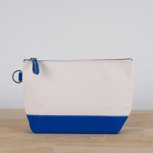 A small heavyweight canvas pouch with a black bottom, featuring a sturdy metal zipper and side loop detail, from the All In Zip Top Pouch collection.