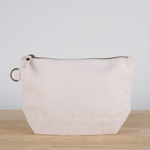 A small heavyweight canvas pouch with a black bottom, featuring a sturdy metal zipper and side loop detail, from the All In Zip Top Pouch collection.