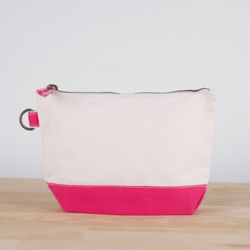 A small heavyweight canvas pouch with a black bottom, featuring a sturdy metal zipper and side loop detail, from the All In Zip Top Pouch collection.
