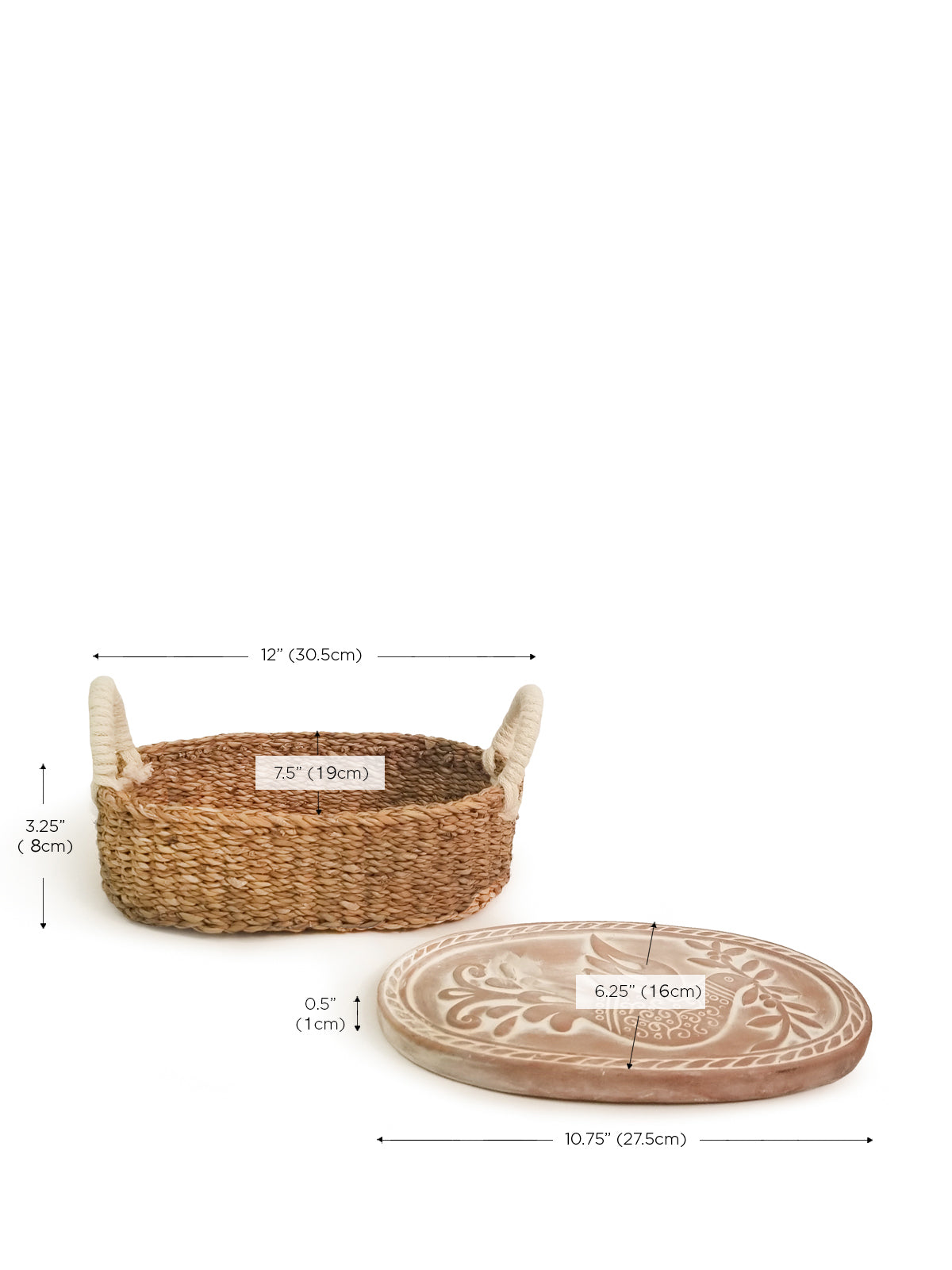 The Bird Oval Bread Warmer & Basket is an expertly crafted product, featuring an oval terracotta platter adorned with a white bird design, set within a handcrafted basket with two loop handles by Fair Trade artisans.
