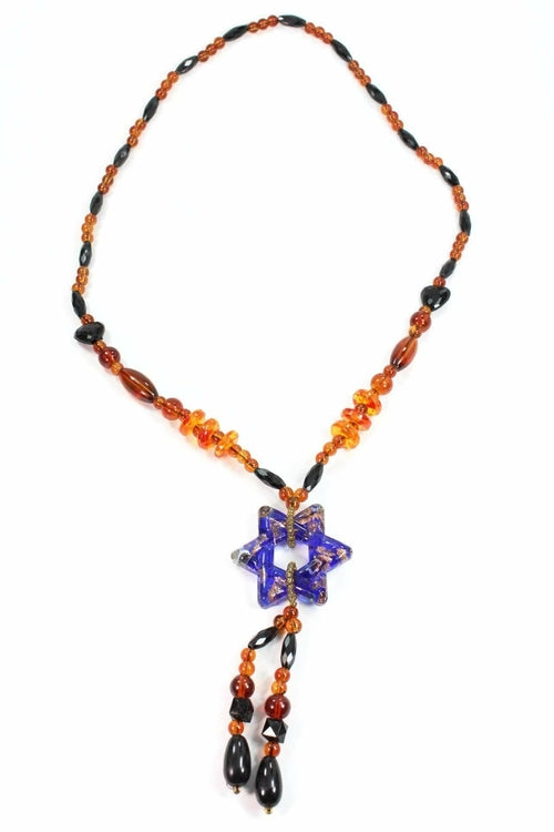 The Star Pendant Gypsy Style Shimmer Necklace features handmade jewelry with colored glass beads and a star-shaped pendant that displays a captivating blue and orange swirl pattern.