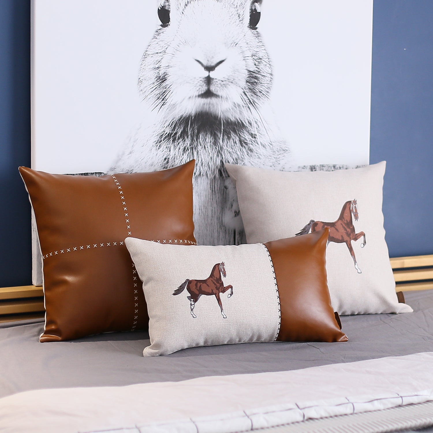 Placed on a brown sofa is the Boho Embroidered Horse Throw Pillow, a solid beige and brown square cushion measuring 18" x 18", featuring an illustration of a horse and made with recycled polyester filling, ensuring OEKO-TEX certification.
