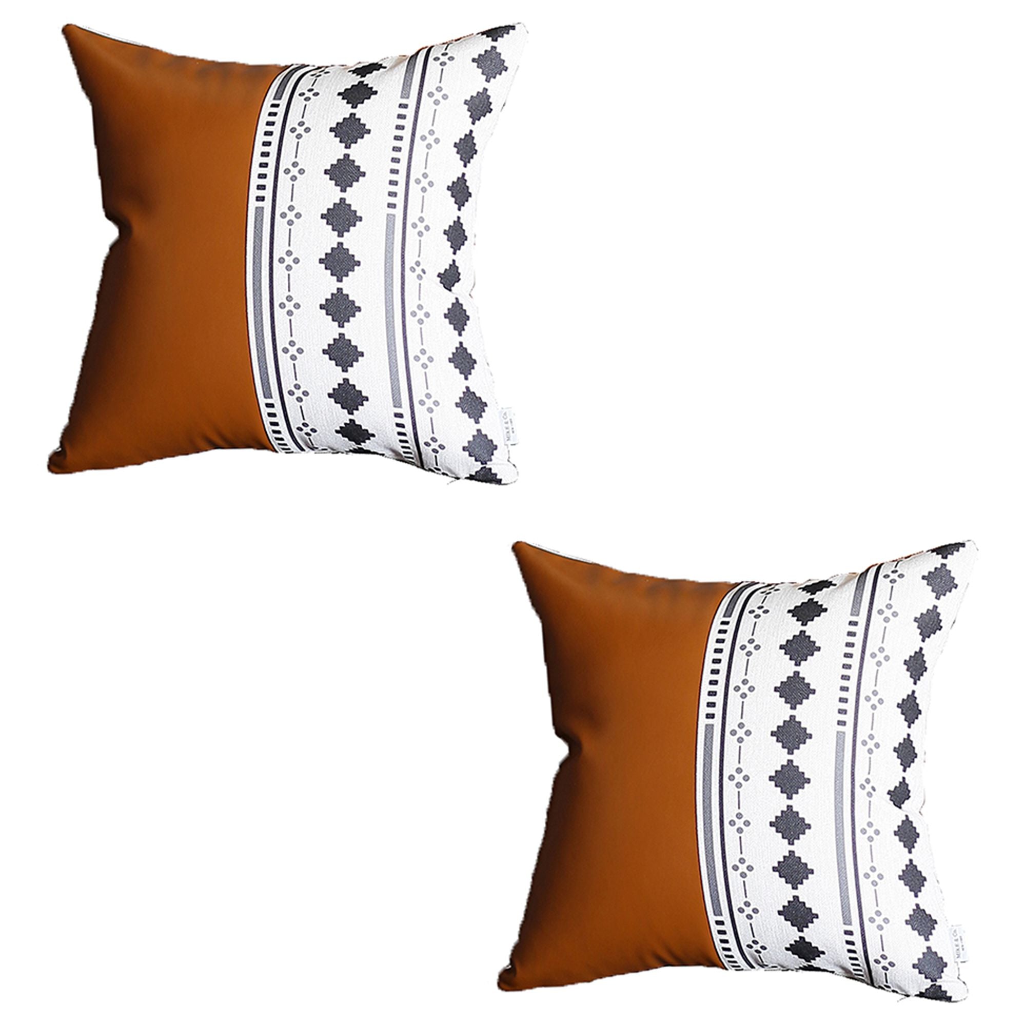 A pair of decorative pillows, featuring one in orange and another with a geometric design, are placed on a gray sofa in a modern living room. The Boho Set of 2 Handcrafted Decorative Throw Pillow Covers, made from vegan faux leather with geometric patterns, add an artistic flair that enhances the chic and cozy feel of the space.