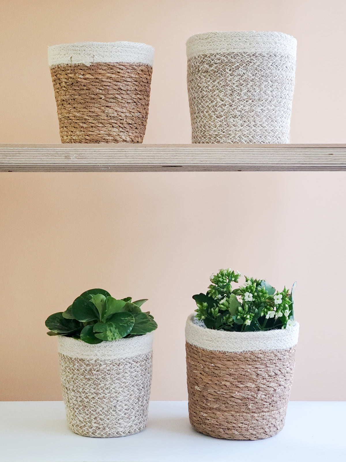The Agora Plant Baskets in a light brown and cream pattern are showcased side by side on a plain white background, highlighting sustainable home decor crafted by Fair Trade artisans.