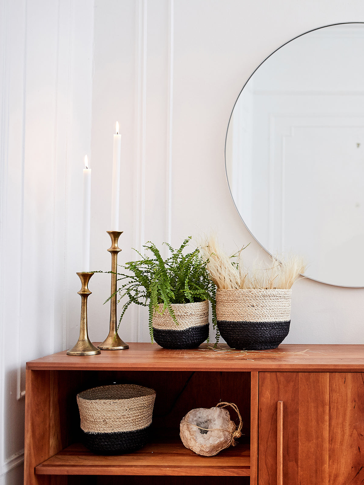 Three Naiya Bin baskets, handwoven by Fair Trade artisans with varying sizes and featuring natural upper halves and black lower halves, are arranged side by side against a light background.