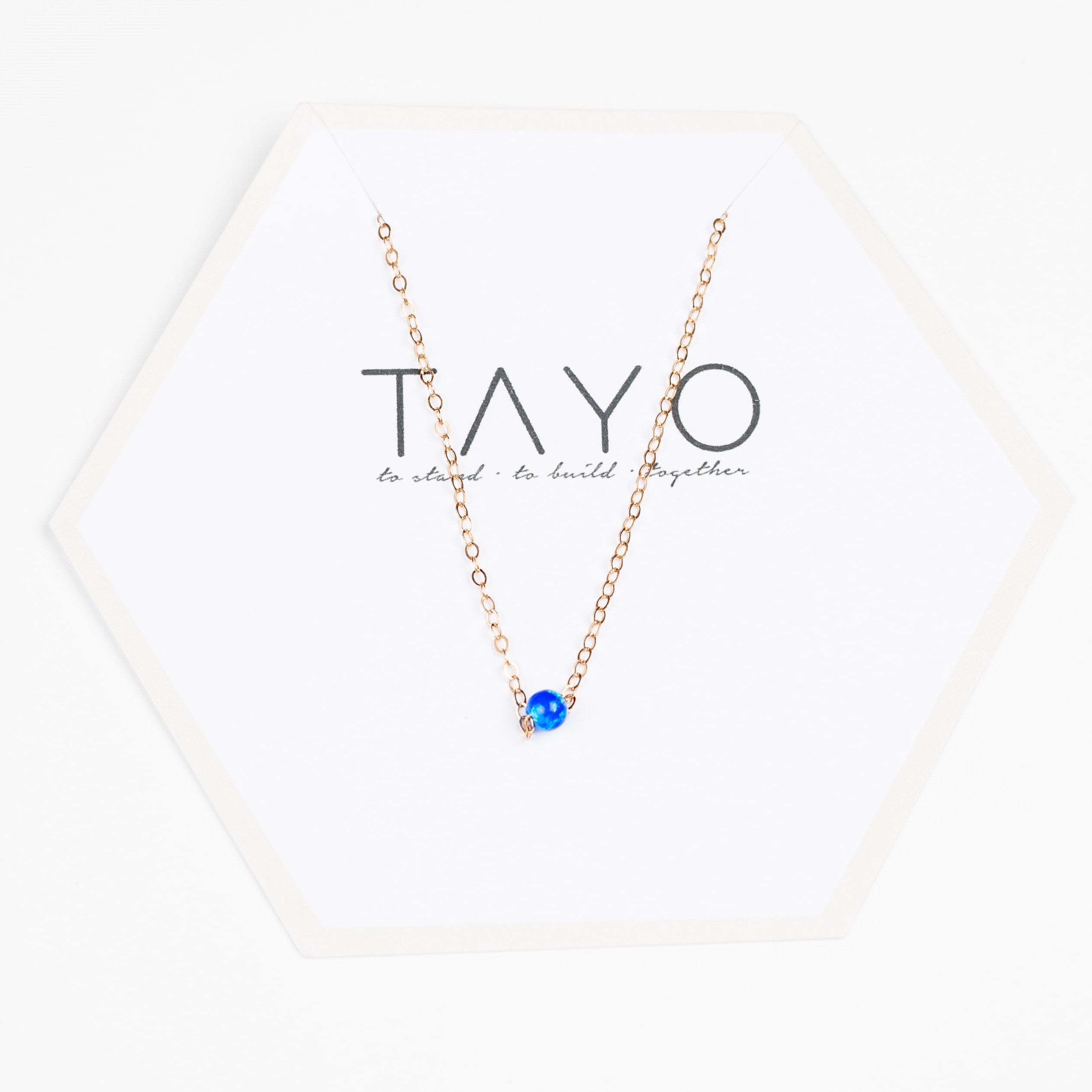 Dark Blue Rebecca Bracelet, showcased on a white hexagonal board featuring "TAYO" and the slogan text below.
