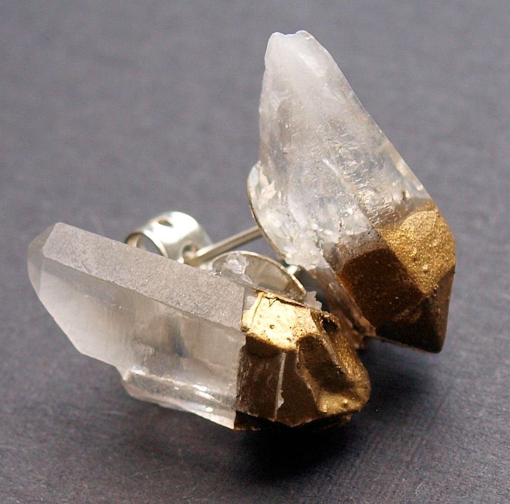 The Gold & Raw Quartz Chunk Earrings, showcasing their raw beauty with gold accents, stand out on a gray backdrop, making a bold statement in the realm of unique jewelry.