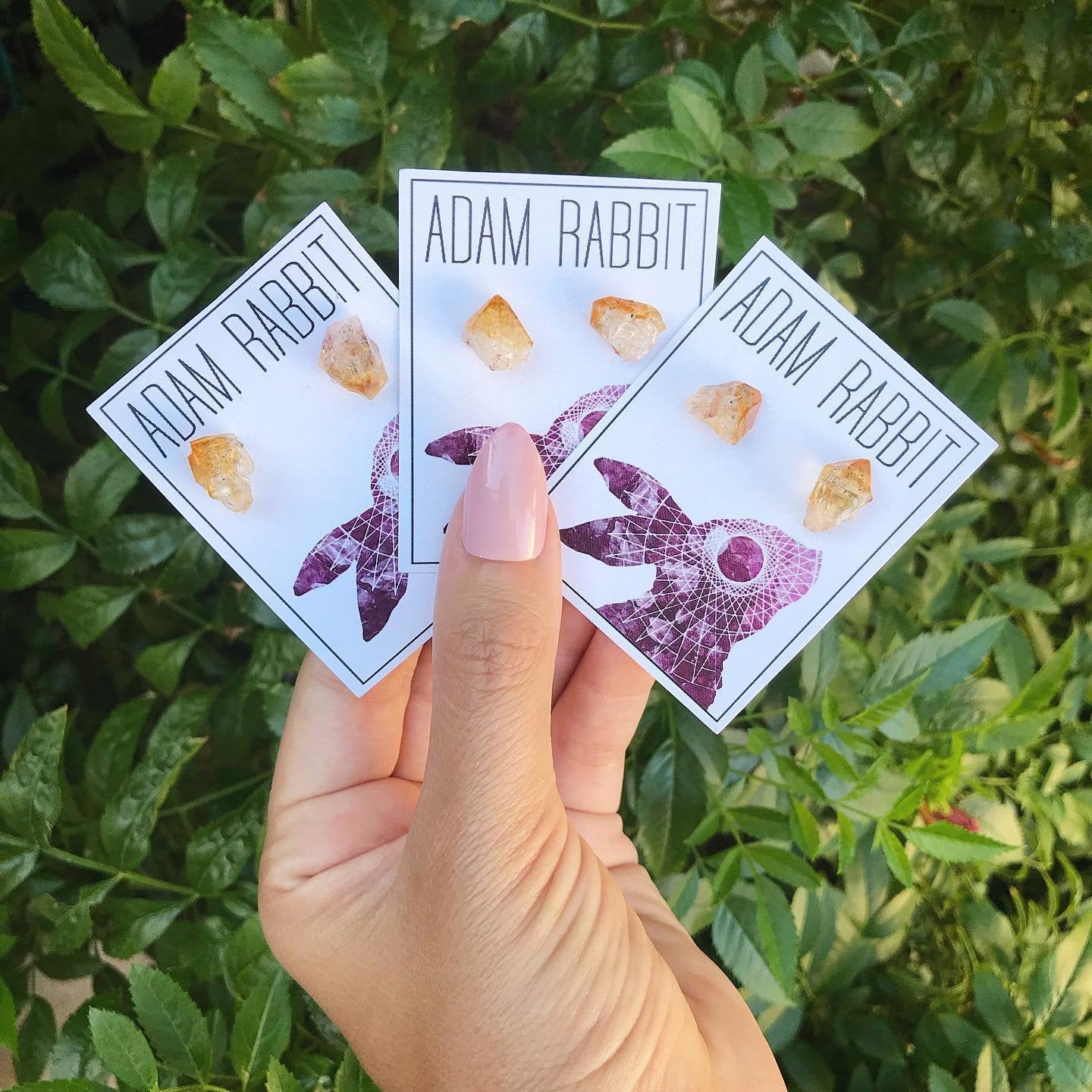 A pair of Raw Citrine Chunk Earrings, also known as Geo Earrings or Rock Stud Earrings, are elegantly showcased on a dark background, highlighting the allure of unique crystal jewelry.
