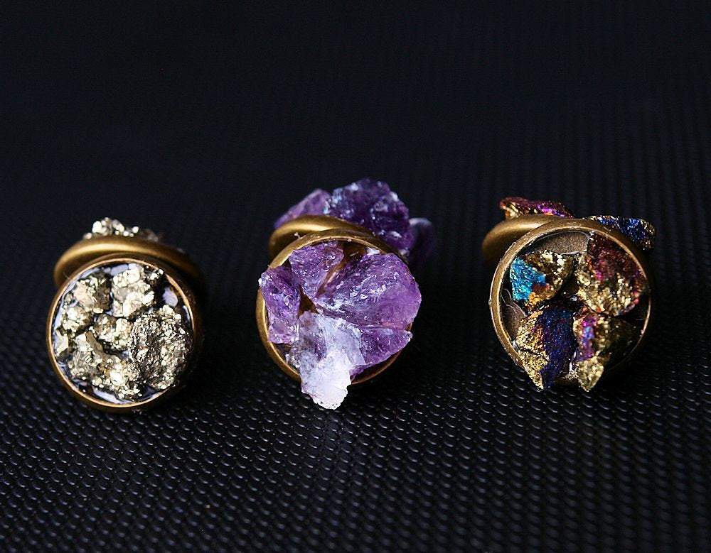 Raw amethyst cluster stud earrings rest elegantly on a textured black surface, offering the perfect touch of luxury for any gift-giving occasion.
