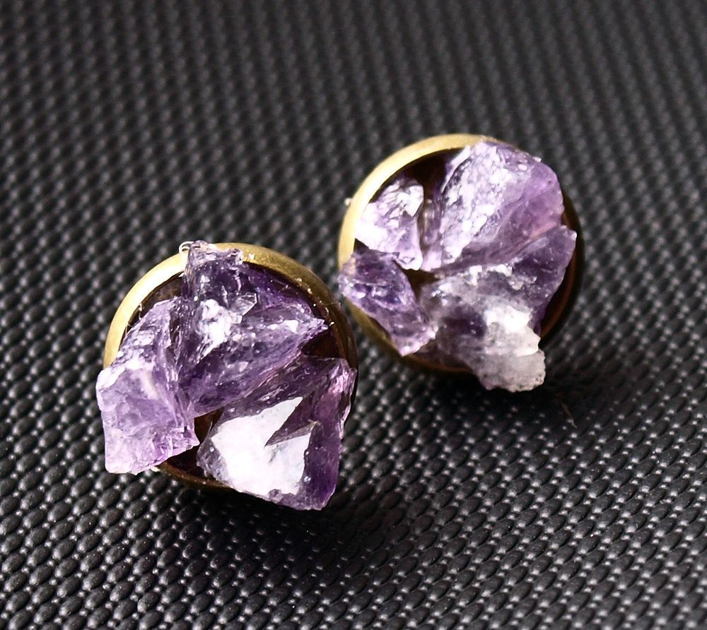 Raw amethyst cluster stud earrings rest elegantly on a textured black surface, offering the perfect touch of luxury for any gift-giving occasion.