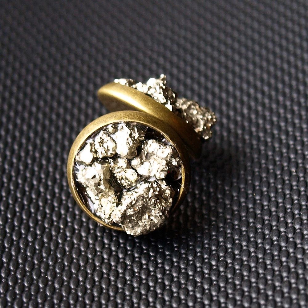 Two Pyrite Cluster Stud Earrings featuring raw pyrite with textured, metallic gold-colored surfaces that resemble clustered nuggets or rocks, set against a dark background.