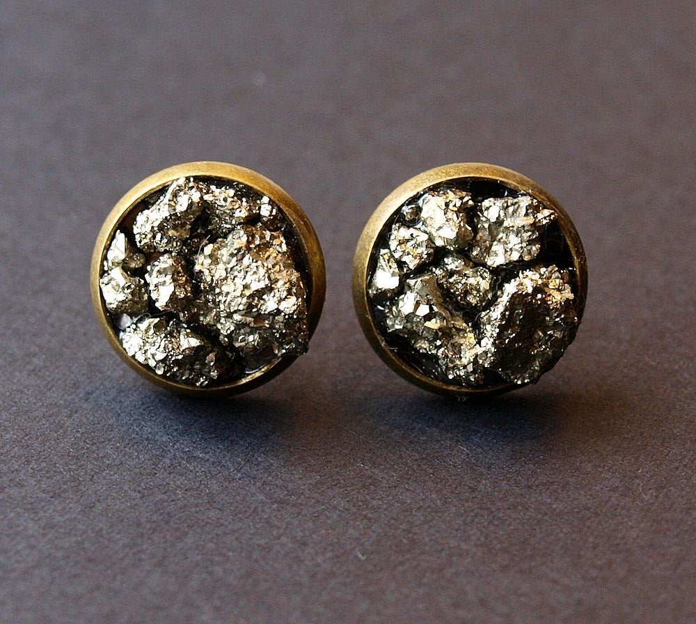 Two Pyrite Cluster Stud Earrings featuring raw pyrite with textured, metallic gold-colored surfaces that resemble clustered nuggets or rocks, set against a dark background.