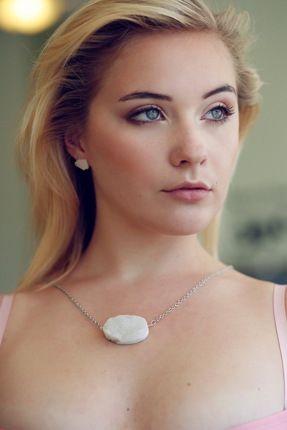 Close-up of a striking pair from the Raw Quartz Chunk Earrings collection, showcasing rough, clear quartz stones set in silver on a dark surface, they make a statement in any collection.