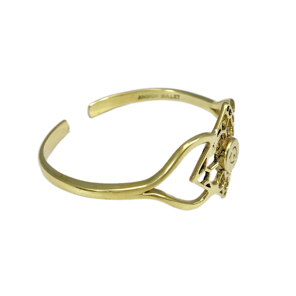 The Angkor Bullet Cuff is a stunning gold cuff bracelet that showcases an intricate openwork floral design, handcrafted with artisan craftsmanship. Made in Cambodia, this unique piece elegantly combines history and artistry by using recycled bombshell jewelry.