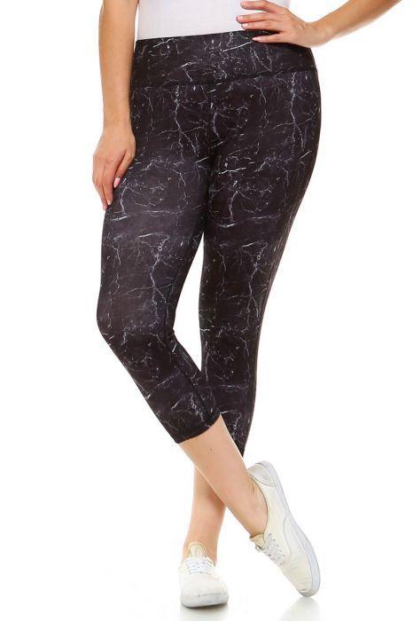 A person wearing Copy of PLUS Black Marble Print Capri Leggings and white sneakers stands with one leg slightly crossed over the other.