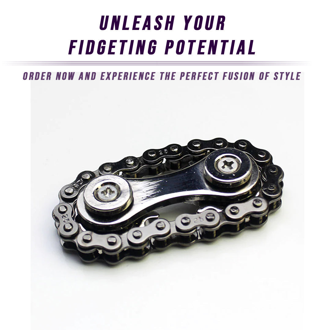 A Bike Chain Gear Spinner with two rivets lies on a glossy white surface, evoking the image of a sleek gear fidget spinner crafted for contemporary stress relief.