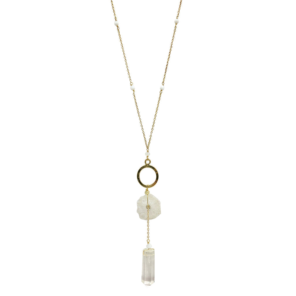 The Solar Quartz + Crystal Y Necklace is an enchanting piece of handmade jewelry, featuring a gold necklace with a circular pendant and two stunning stones, including solar quartz.