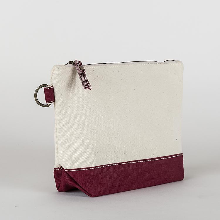 A small heavyweight canvas pouch with a black bottom, featuring a sturdy metal zipper and side loop detail, from the All In Zip Top Pouch collection.