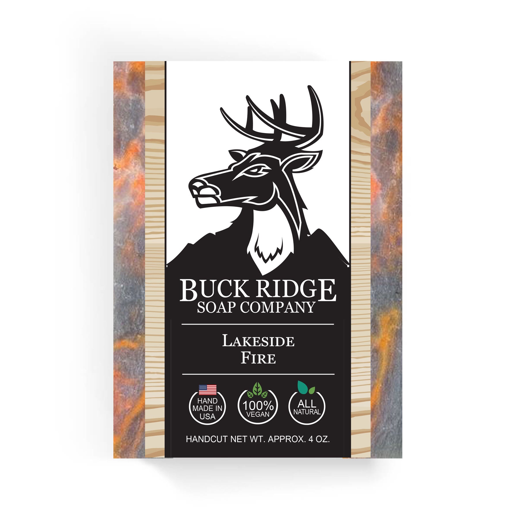 The "Lakeside Fire Handmade Soap" from Buck Ridge Soap Company features a deer logo and highlights its "Handmade in USA," "100% Vegan," and "All Natural" qualities. This luxurious soap is part of our natural skin care line and has a net weight of 4 oz.