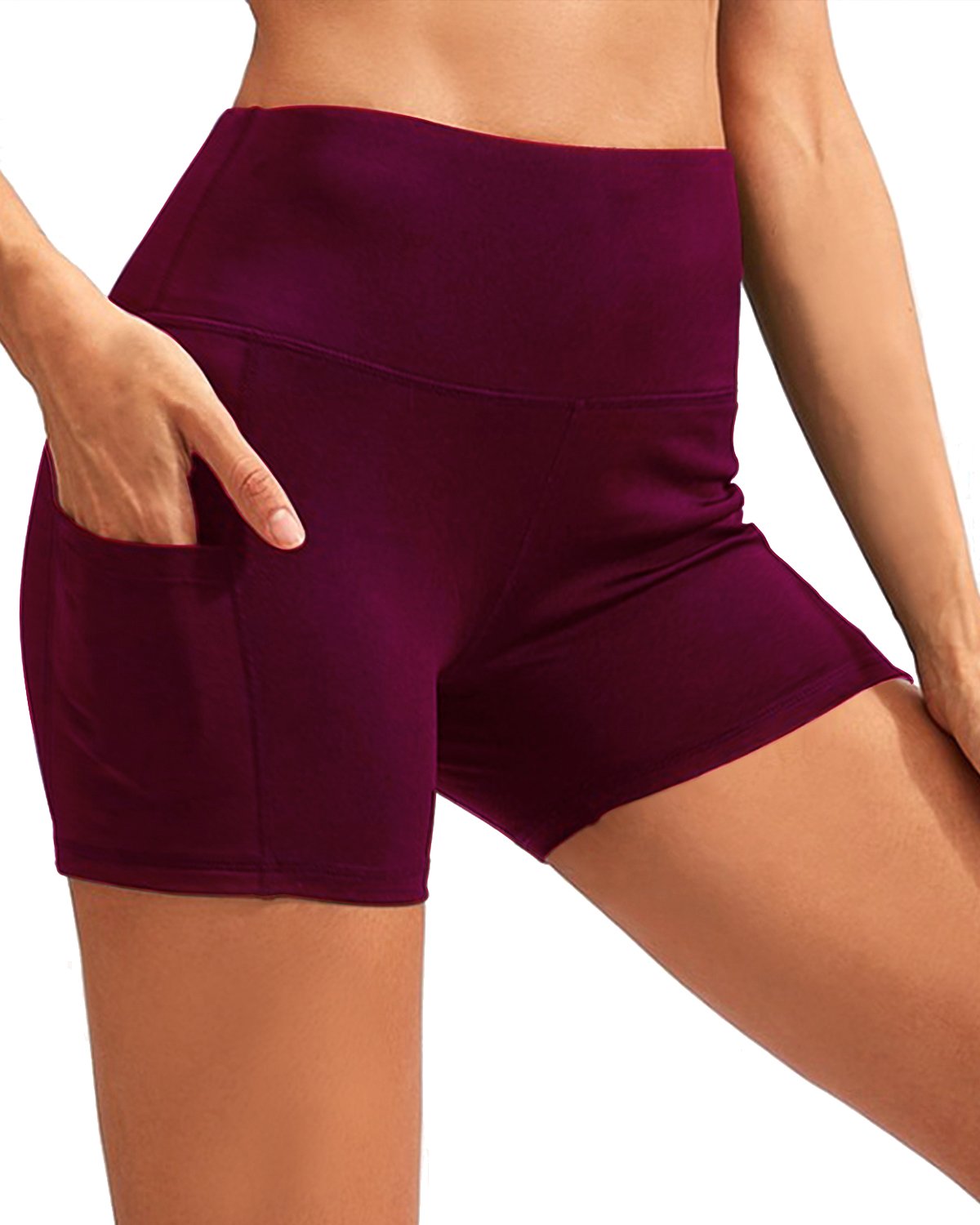 A person wearing red high-waisted yoga shorts with pockets stands against a white background, shown from mid-torso down. The CALCAO High Waist Yoga Shorts emphasize a sculpted fit that perfectly complements the high-rise waist.