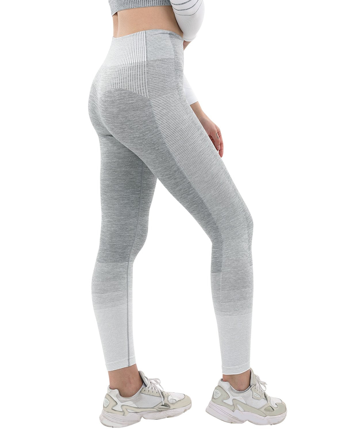 A person showcases Bocana Seamless Leggings in grey & white against a white background, paired with white sneakers.