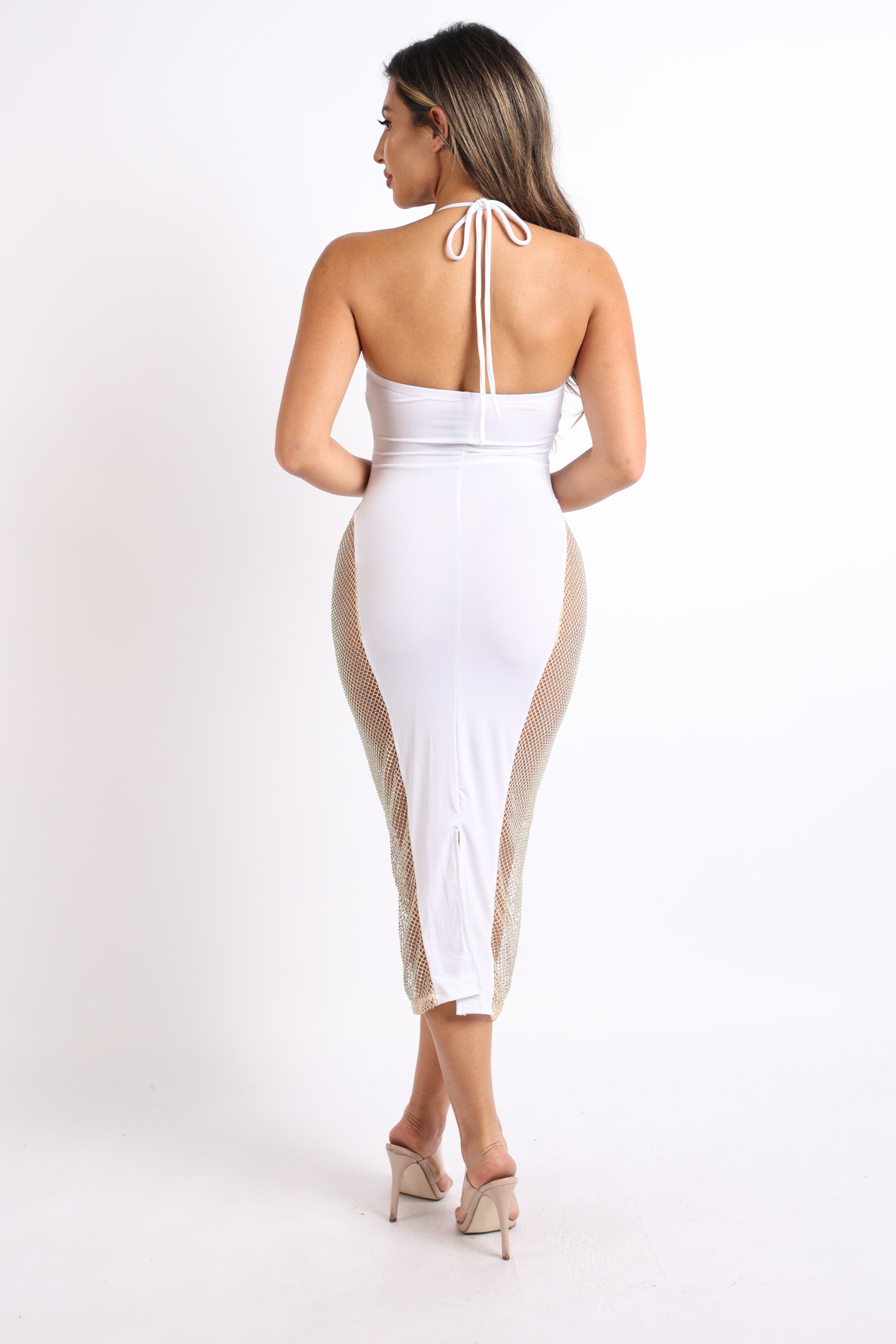 Wearing the Sexy Cut Out Rhinestone Fishnet Contrast Clubwear Party Dress in white, a person poses confidently against a plain backdrop, ideal for clubwear.