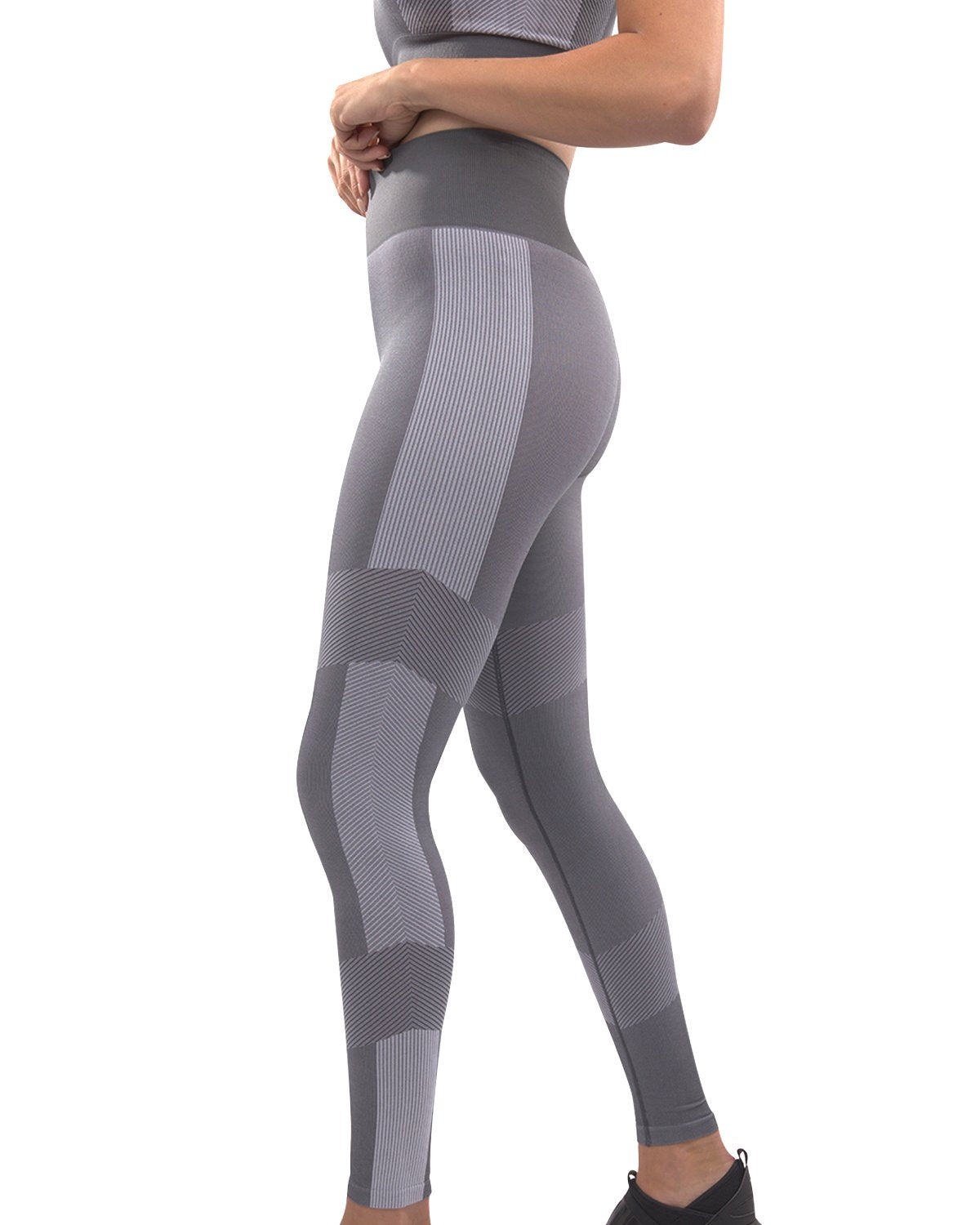 A person wearing high-waisted Arleta Seamless Leggings in grey, featuring geometric patterns, is shown from the back against a white background.
